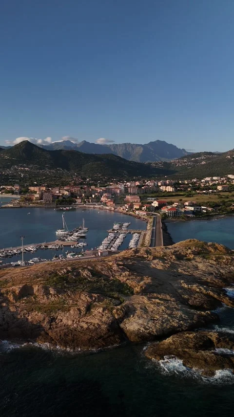 Sunrise Drone Flight Towards L'Île-Rousse Over Marina and Coast