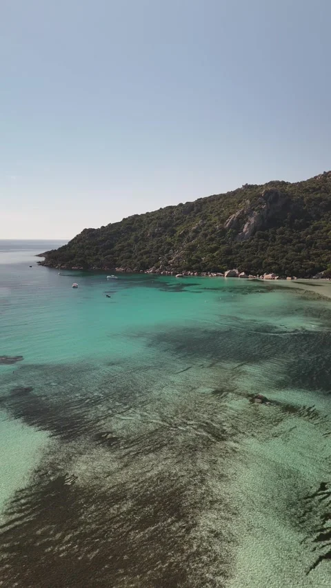 Vertical Aerial Flight Over Bay Towards Green Hillsides of Santa Giulia, Corsica