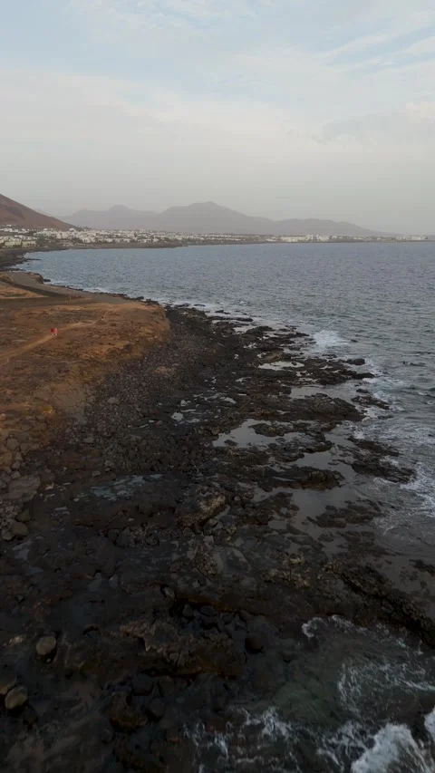 Bird's Eye Flight Over Volcanic Coastline Towards Playa Blanca, Lanzarote