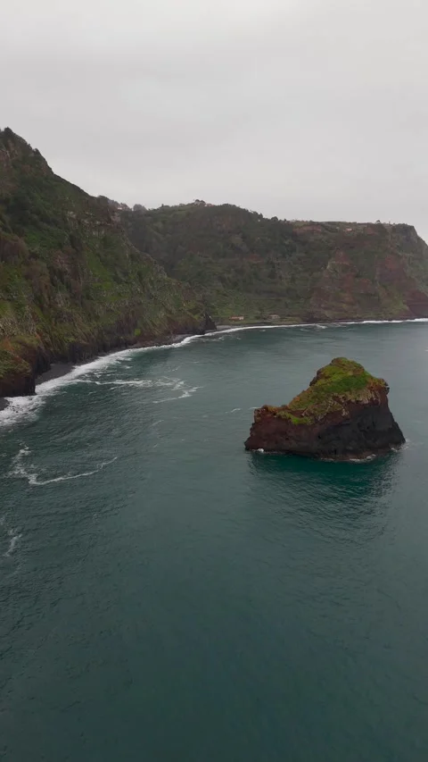 Vertical Drone Flight Past Towering São Jorge Cliffs Towards Sea Stack Vertical Drone Flight Past Towering São Jorge Cliffs Towards Sea Stack