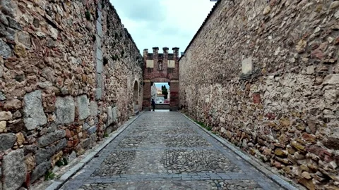 Walking Through Narrow Stone Street Towards Archway in Segovia Old Town