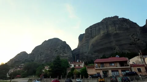 Looking Up Panning Shot of Meteora Rock Formations Looming Over Kalabaka Town