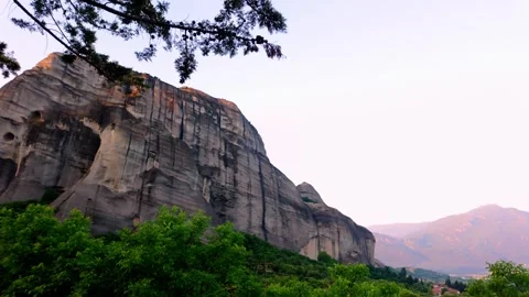 Golden Morning Light on Meteora Rock Formation Under Tree Canopy
