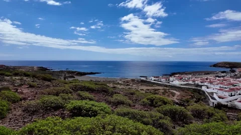 Pan across Abades coastline, modern settlement and beach, Tenerife, Spain.