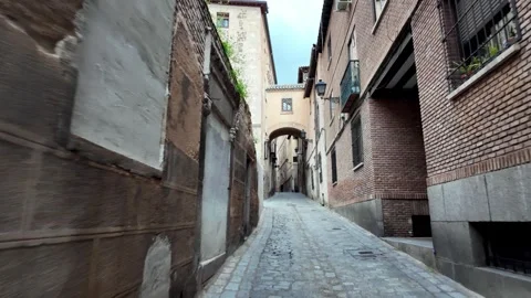 Walking Through Narrow Old Town Street Towards Crossing Archway, Toledo Walking Through Narrow Old Town Street Towards Crossing Archway, Toledo