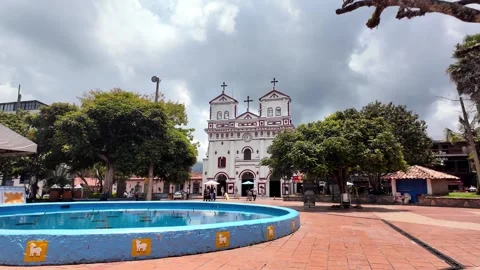 Walking Through Main Square Guatape Towards Nuestra Señora Del Carmen Church