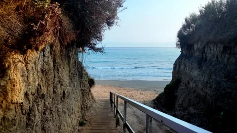 Walking Down Wooden Steps onto Scenic Apotripiti Beach, Sidari, Corfu, Greece Walking Down Wooden Steps onto Scenic Apotripiti Beach, Sidari, Corfu, Greece