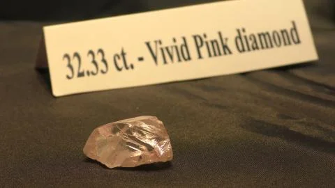 A 32.33 carat vivid pink rough diamond is presented for auction Stock Photos