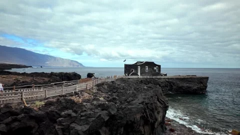 Wide Pan Over Moody Coastline and Muelle Punta Grande Pier, Las Puntas