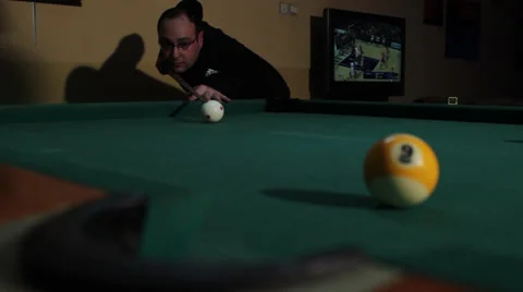 32/35 Man playing billiard. Player is taking a shot and put ball in the hole. Stock Footage 36427130
