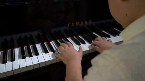 3/3 Closeup of Boy hands playing old vintage piano keyboard Stock Footage 203841153