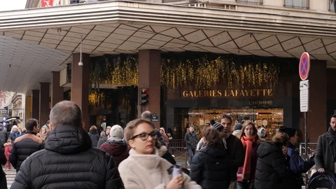 33 Rainy gray winter day Paris Lafayette Gallery entrance people crowd walkin Stock Footage 100813330