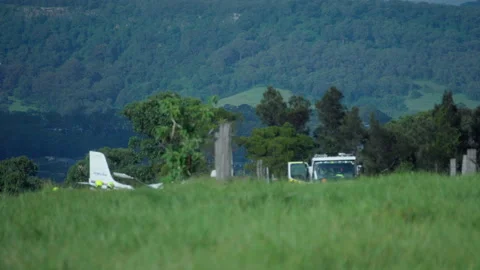 3/4/26: Editorial Tail of Crashed Plane Visible Over Hill and emergency Lights Stock Footage 332031710