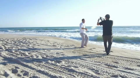 347 Behind the scenes of a video on the beach Stock Footage 138445289