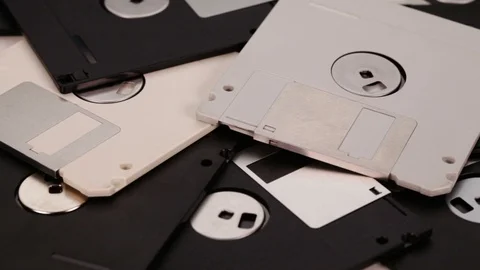 3.5 inch computer floppy disks scattered on a flat surface Stock-Footage 90645342