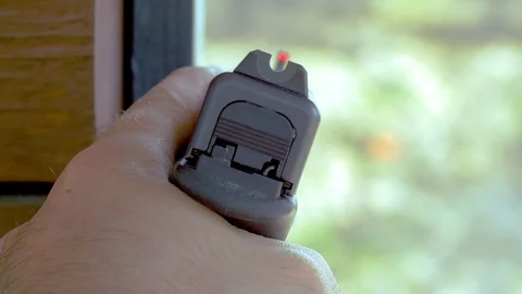 352 Closeup of a gun while aiming around a corner Stock Footage 122939014