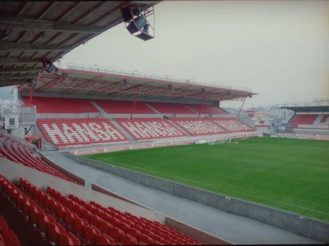 35mm 2k EXT DAY- EMPTY FOOTBALL STADIUM-FEW PLAYERS PRACTICE Stock Footage 75364315