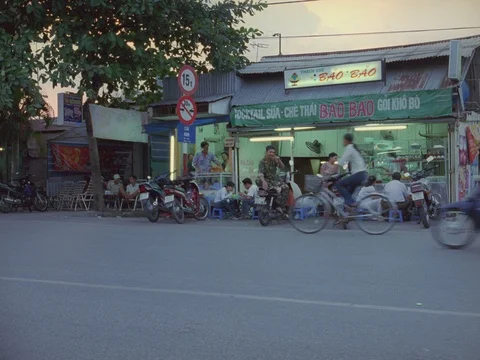 35MM 2K EXT. DAY SAI GON , VIETNAM- CAFE W MOTORBIKES TRAFFIC  Stock Footage 75375199