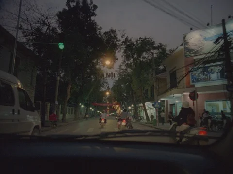 35MM 2K EXT. DUSK HANOI , VIETNAM- CAR POV THRU WINSHIELD- MOVING W TRAFFIC  Stock Footage 75376077