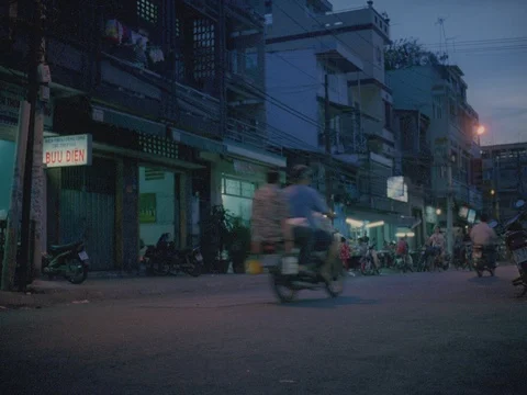35MM 2K EXT DUSK-SAIGON VIETNAM- STREET LIFE LADY CARRY SLING BASKETS, TRAFFI Stock Footage 75375014