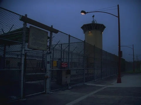 35MM 2K EXT. DUSK STATE PRISON- VISITOR ENTRY GATE Stock Footage 75364033
