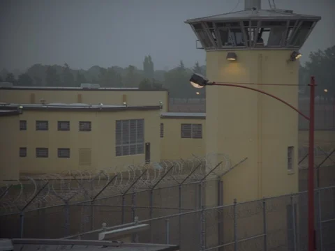 35MM 2K EXT. DUSK STATE PRISON- CLOSE GUARD TOWER ,PAN INTO PRISON 動画素材 75364225