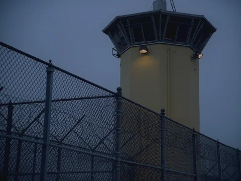 35MM 2K EXT. DUSK STATE PRISON- GUARD TOWER- SLOW ZOOM IN 動画素材 75364247