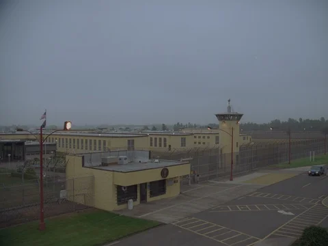 35MM 2K EXT. DUSK STATE PRISON- WIDE TOWER, PRISON BUILDINGS AND FENCE 動画素材 75364443