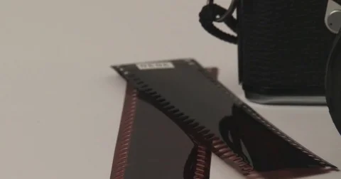 35mm Camera - Close up of Lens with Negatives Stock Footage 84871655