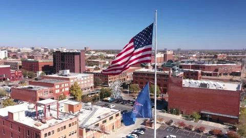 360 aerial motion view OKC Thunder flags over Bricktown downtown Oklahoma City Video stock 222575533