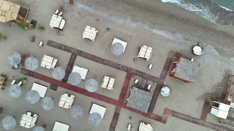 360 aerial view above beach cabanas and boardwalks by the sea Vídeo Stock 310043255