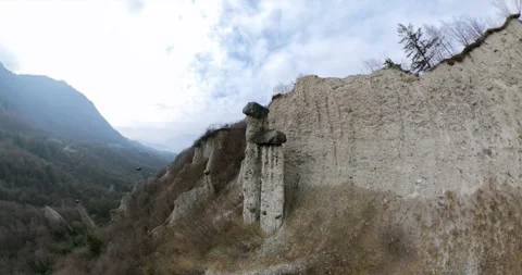 360 aerial view of earth pyramids of Zone near Lake Iseo, Italy Stock Footage 342673782