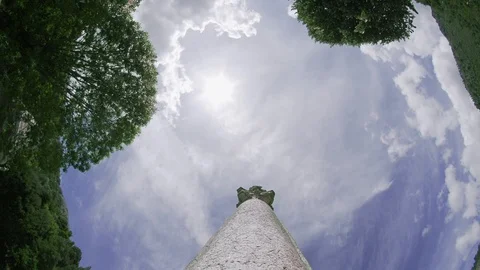 360 angle view of stone column with cloudy sky and trees Stock Footage 128961946