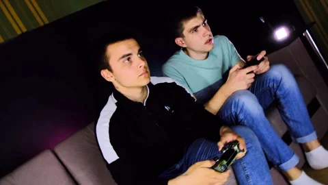 360 barrel camera roll. Two young guys are sitting on the couch in front of the Stock Footage 131173619