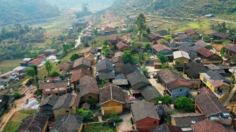 360 degree drone orbit over an ancient ethnic mountain hamlet 4K Stock Footage 339044936