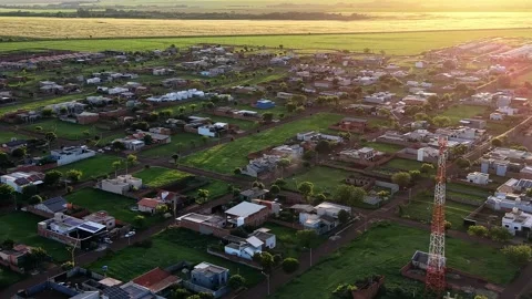 360 Degree Drone Rotation Over Residential Area and Farmland at Golden Hour Stock Footage 346794228