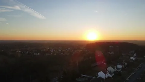 360 Degree Panoramic Drone Shot of a Sunset Over A Quiet Suburban Town Stock Footage 228699140