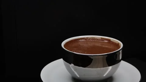 360-degree view in 4K of frothy coffee inside silver-reflecting coffee cup. Stock Footage 248572435