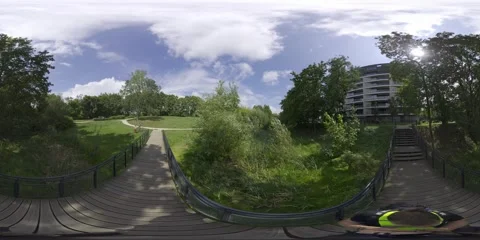360-Degree View of a Park with a Bridge, Trees, and a Building Stock Footage 282661667