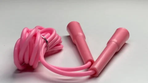 360 degree view of pink skipping rope for an exercise, isolated on white Stock Footage 276200542