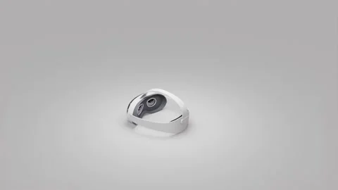 A 360-degree view of a white VR headset on a gray background Stock Footage 282856544