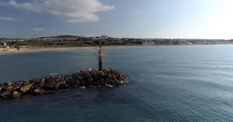 360 drone flight around a lighthouse on the coast of the Mediterranean Sea Stock Footage 93897327
