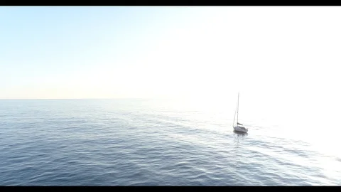 360 drone flight around a sailing boat at sea Stock Footage 97794389