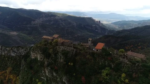360 drone flight around a small mountain town Stock Footage 122299051