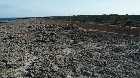360 drone flight around a stone shelter on the island of menorca Stock Footage 117632457