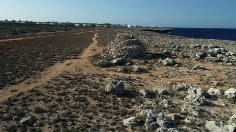 360 drone flight around a stone shelter on the island of menorca Stock Footage 117632638