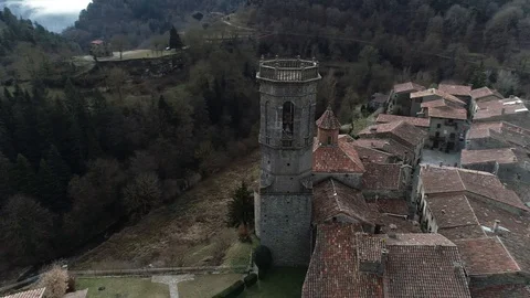 360 drone view around the bell tower of a small mountain town Stock Footage 102215418