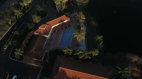 360 Fly around Swimming pool at sunset with drone Stock Footage 146876587