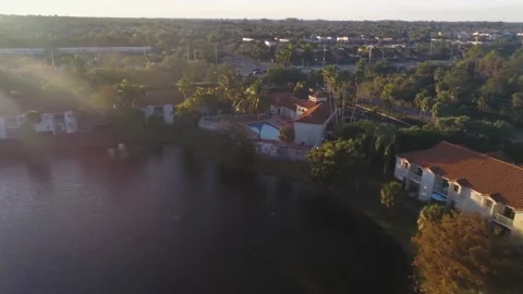 360 Fly around Swimming pool at sunset with drone Stock Footage 146876590