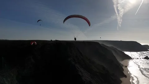 360 Of Paraglider soaring Portuguese Cliffs. Smooth drone Tracking Stock Footage 296203729